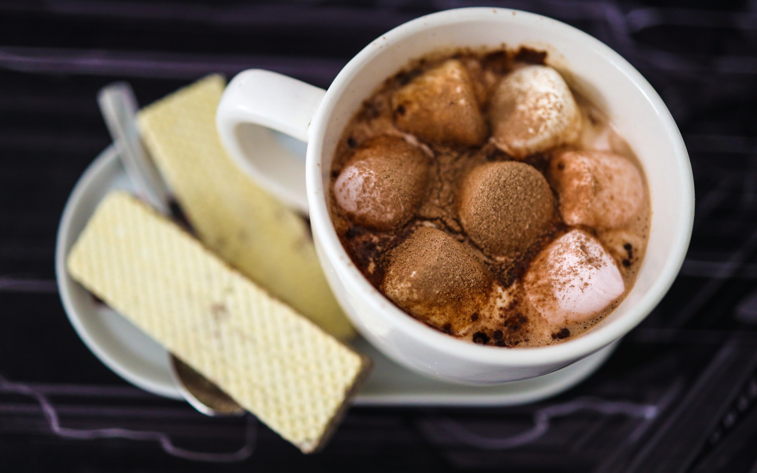 Чашка какао с маршмеллоу на тарелке с вафлями