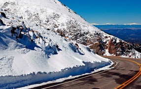 Road among snow tops
