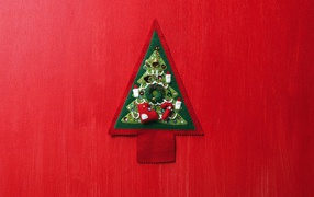 Christmas tree made of fabric on the red wall on Christmas