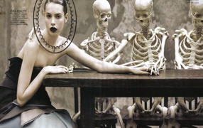 Girl with skeletons at the table