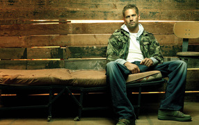 Famous Actor Paul Walker is resting on a bench