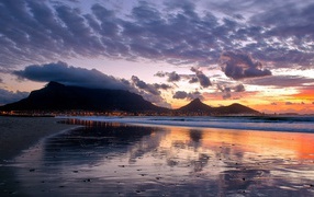 Sunset on the beach over the mountains