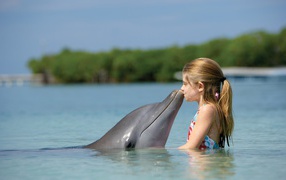 	 Girl kissing Dolphin