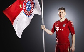 Bayern Bastian Schweinsteiger with a flag