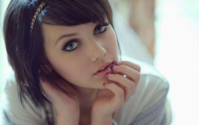 Beautiful young brunette woman with short hair and a pierced nose