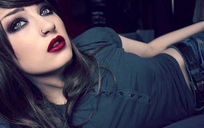 Brunette girl with a pierced nose and burgundy lipstick