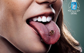Brunette girl with pierced tongue
