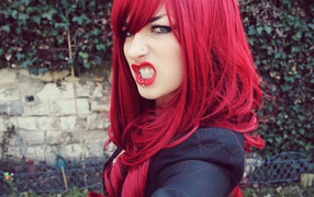 Girl with red hair and pierced nose and lip