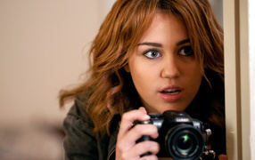 Miley Cyrus with a camera
