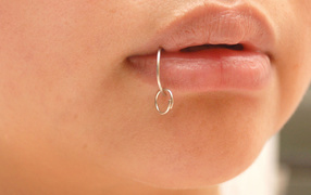 Piercing in the lip of the girl