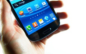 Samsung Galaxy S3 in hand on a white background