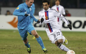 The defender of Zenit Alexander Anyukov is trying to take the ball