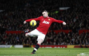 The football player of Manchester United Wayne Rooney is hitting a ba