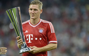 The halfback of Bayern Bastian Schweinsteiger with his own trophy