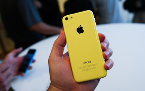 Yellow Iphone 5C in hand