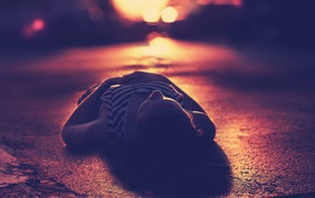 Girl lying on the pavement