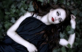 Vampire girl lying in leaves