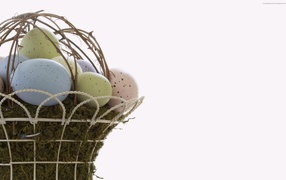 Eggs in a basket on a white Easter