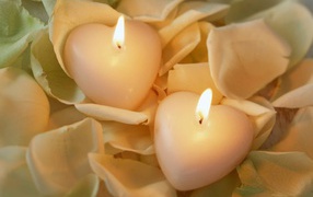 Two candles in the shape of heart on Valentine's Day February 14