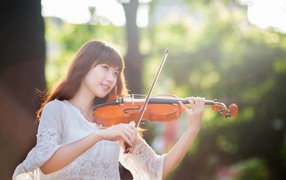 Cute little girl with a violin and bow