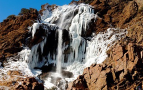 Frozen waterfall on stone mountain
