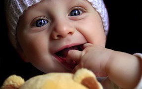 Cute baby playing doll