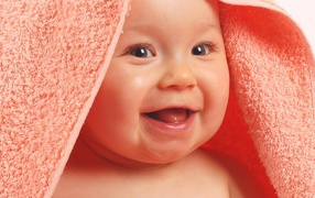 	  Baby in a towel laughs