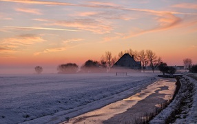 The snow-covered field in the fog