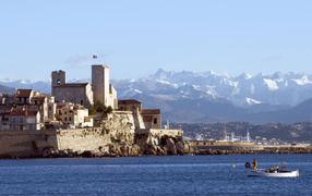 Castle on a background of mountains in the resort of Antibes, France