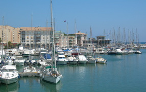 Yacht on a background of buildings on the resort of Port de Frejus, France
