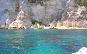 Boat on the background of rocks on the island of Ponza, Italy