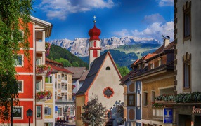 Church on a background of mountains in Ortisei, Italy