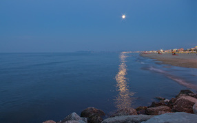 Moonlight on the beach in the resort of Rimini, Italy