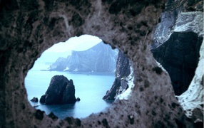 View of the bay through the rocks on the island of Ponza, Italy