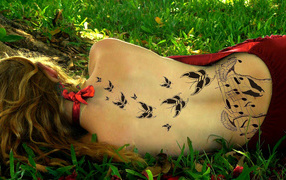 Butterfly tattoo on the back of a girl