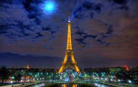 Eiffel Tower and cloudy sky, night photo