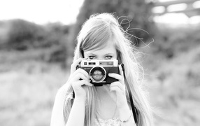 Girl with camera, black-and-white photo