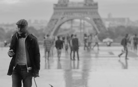 Man with dog near the Eiffel Tower, black and white photo