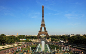 People rest near the Eiffel Tower and fountains