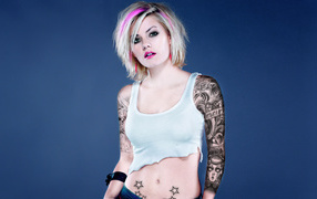 Rebel girl with a tattoo on his arm and abdomen