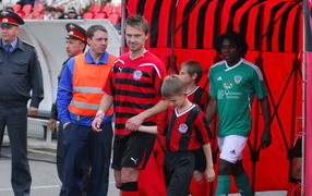 Sergei Volkov striker Amkar with young footballer