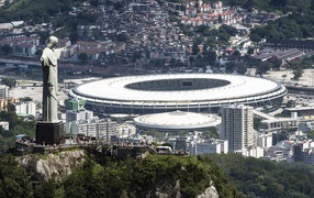 Statue of Christ on a background of the stadium at the World Cup in Brazil 2014