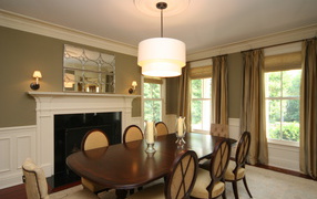 White chandelier over the table in the dining room