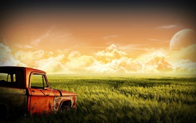 Old car on the green field