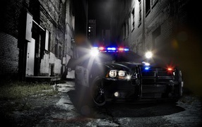 Police car in a dark alley