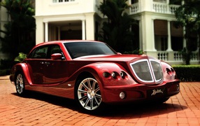 Red luxury car on the paved path