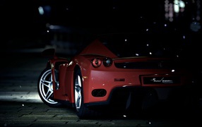 Red sports car on a dark street