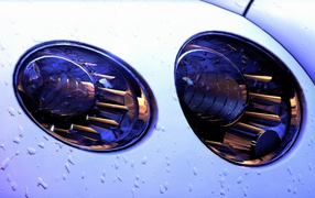 White headlights of the car, rain