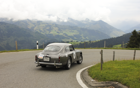 The old model of Aston Martin in the mountains