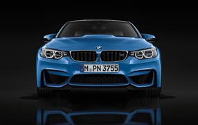 Blue BMW M3 in a black room